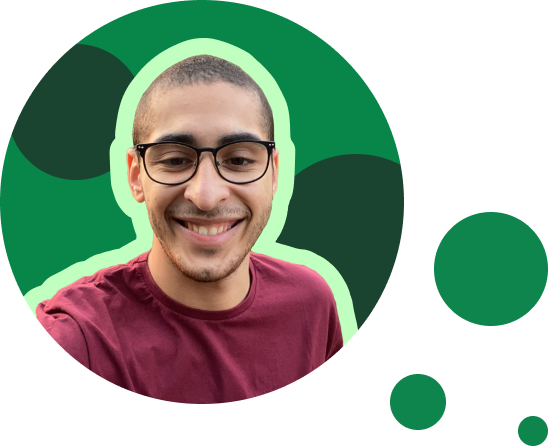 In the foreground is Erick Almeida, a young Latino man with short hair and brown eyes wearing glasses. He is smiling and wearing a burgundy shirt. The photo shows only the bust, over a green circle. Around it is three smaller green circles.